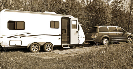 Vintage Camper and Van parked at campsite.  Sepia Tone. 