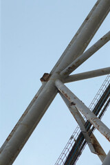 This image features a detailed closeup view of a robust metal structure, prominently set against a...