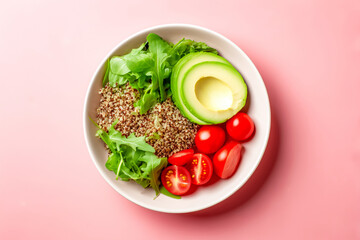 White bowl of quinoa salad with avocado and cherry tomatoes on pink background image