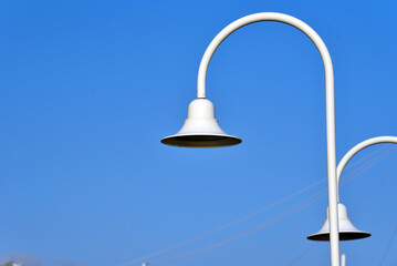 Street lamps overlooking the sea in the Expo area of Genoa, Italy