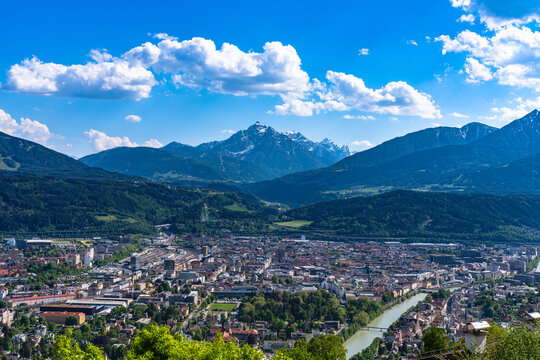Aerial panorama view of Innsbruck city with peak Serles and the massif of Tyrolean alps from Hungerburg cable car station in spring on a sunny day, Innsbruck, Austria
