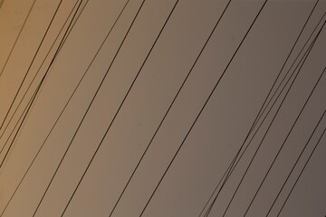 Obraz premium This is a closeup view that showcases a row of power lines situated on a buildings structure, emphasizing their detail and presence