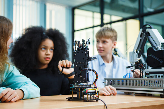 Group of diverse students learning how to use digital devices and AI tools in modern science class, exploring automation and future innovation through real-world applications. - Powered by Adobe