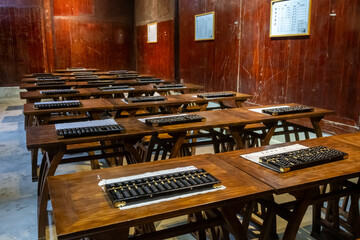 An old classroom with abacuses, suanpan at Huangling Village in Jiangxi. These traditional...