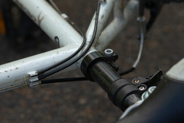 This image features a closeup view of a bicycle handlebar, showcasing a brake lever that is securely attached to the handlebar itself