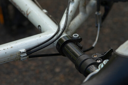 This image features a closeup view of a bicycle handlebar, showcasing a brake lever that is securely attached to the handlebar itself