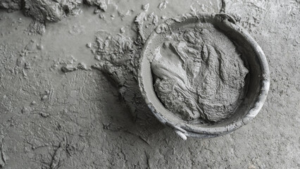 fresh wet mixed cement mortar inside bucket by close up view