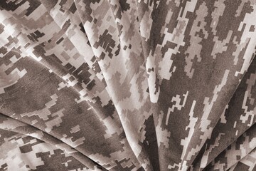 Texture of Dark green pixel camouflage military uniform textile cloth with folds