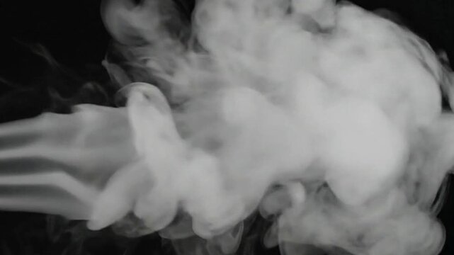 White smoke spreads against a black backdrop resembling billowing clouds