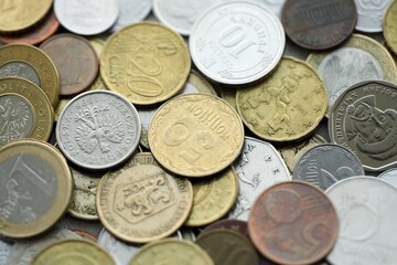 Big pile of different coins from various currencies and different countries around the world. Currency exchange