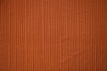 Bright orange fabric background from a piece of crumpled clothes