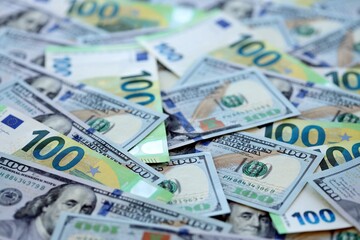 Big pile of Euro and USD banknotes. Many european and united states dollars