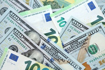 Big pile of Euro and USD banknotes. Many european and united states dollars