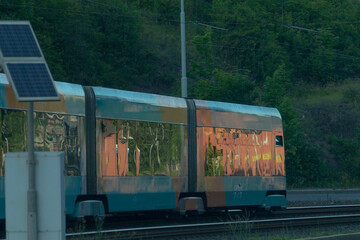 A train featuring a solar panel installed on the side, harnessing solar energy for more sustainable...