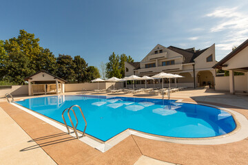 Outdoor swimming pool at a modern luxury resort on a sunny day