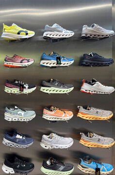 BANGKOK ,THAILAND  July 15, 2025 : On Cloud Running shoes are against the wall on display at a running shoe specialty store. On is a Swiss Company at siam paragon department store