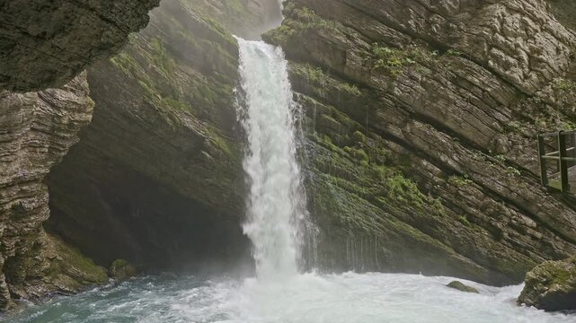 Waterfall in the mountains. The water cascades down from steep rock faces. Thur Waterfall. Waterfall in Unterwasser, Canton of St. Gallen, Switzerland