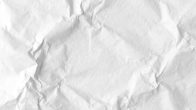 White crumpled paper reveals an uneven texture  shadows from folds  creases