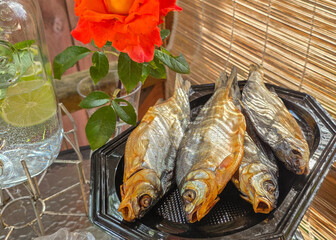 Dried fish, salt snacks on picnic table. Salty dry river fish snack for beer. 
