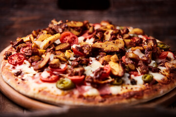 Gyros Pizza with jalapeno pepper, cherry tomatoes and mozzarella cheese. Soft focus. Close up.	