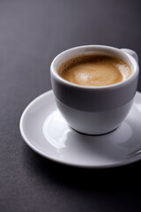 Cup of coffee on paper background. Close up. Copy space.