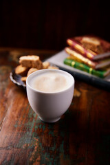 Cappuccino on dark wooden background. Soft focus. Close up.	