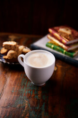 Cappuccino on dark wooden background. Soft focus. Close up.	