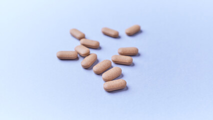 Ashwagandha (Withania somnifera) tablets on paper background. Soft focus. Close up. Copy space.	