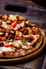 Gyros Pizza with jalapeno pepper, cherry tomatoes and mozzarella cheese. Soft focus. Close up.