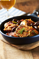 Grilled chicken pieces with kalamata olives and fresh rosemary. Close up.