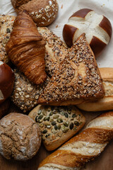 Various types of crusty German breads and flaky pastries offer a delicious spread, perfect for a breakfast or brunch setting