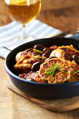 Grilled chicken pieces with kalamata olives and fresh rosemary. Close up.