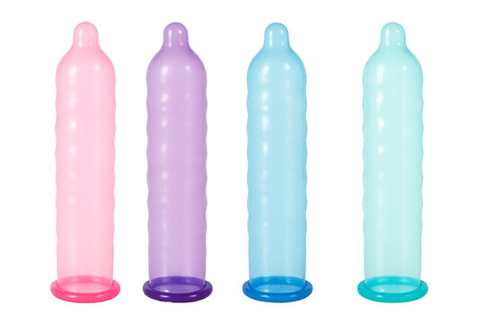 Set of multi-colored unrolled latex condoms, on an isolated background. Condoms, contraceptives for safe sex, prevention of STDs, sexual health.