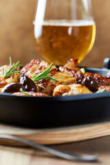 Grilled chicken pieces with kalamata olives and fresh rosemary. Close up