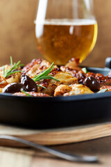 Grilled chicken pieces with kalamata olives and fresh rosemary. Close up.