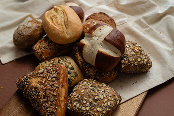 Various types of crusty German breads and flaky pastries offer a delicious spread, perfect for a breakfast or brunch setting