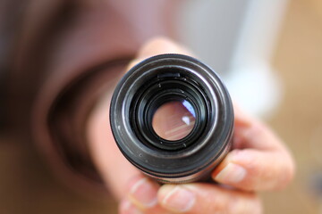 close up of a hand holding a lens