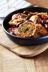 Grilled chicken pieces with kalamata olives and fresh rosemary. Close up.