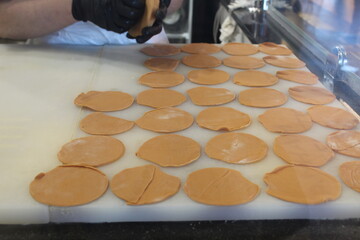 Modeling dumplings, khinkali, manty. Rolled out dough circles laid out on the table