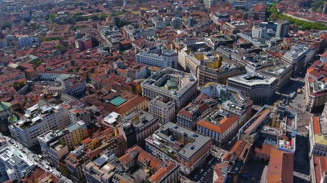 Stunning aerial footage capturing Milan&rsquo;s historic city center, showcasing dense urban architecture, vibrant terracotta rooftops, bustling streets, classic Italian landmarks. European cityscape, Italy