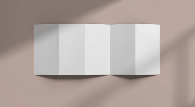 Blank accordion fold brochure or map on a textured surface with shadows