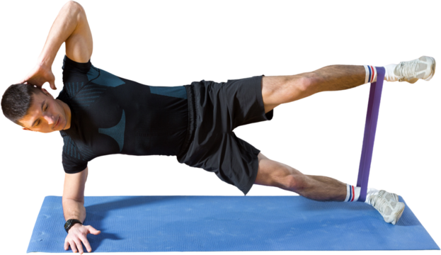 Athletic guy in sportswear and fitness tracker doing exercises in gym.