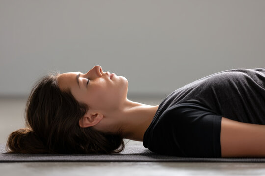 A woman is in a relaxed pose during a yoga and meditation session, feeling the peace.