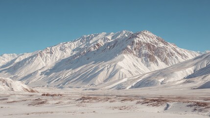 Snow Covered Mountain Range Under a Clear Blue Sky