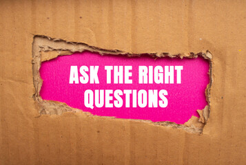 Ask The Right Questions message written on ripped torn cardboard paper on pink background. Conceptual Ask The Right Questions symbol. Copy space.