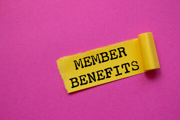 Member benefits message written on ripped torn yellow paper piece on pink background. Conceptual...