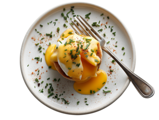 A meticulously styled and appetizing Eggs Benedict. The poached egg's vibrant yolk is on display as it's gently sliced to create a delicious dining experience.