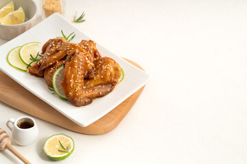 Honey Lemon Glazed Chicken Wings with Sesame and Lime.