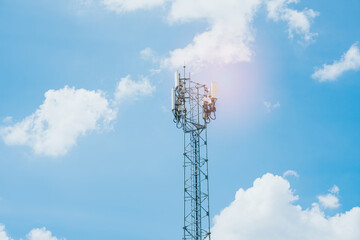 Telecom Tower Against Bright Blue Sky and Fluffy Clouds