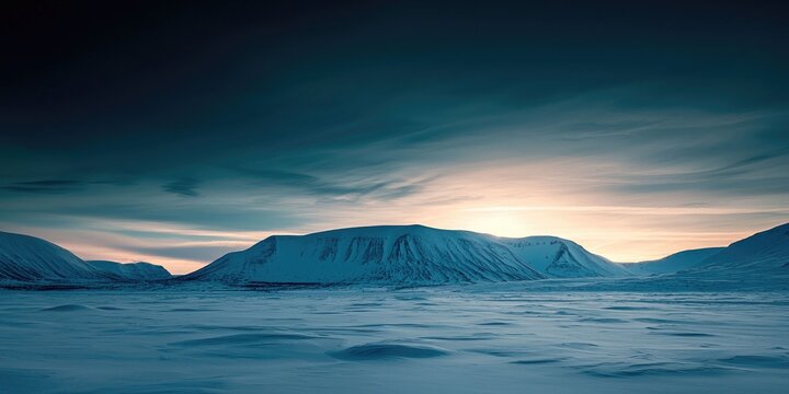 High-res wallpaper of snowy mountain silhouettes beneath Arctic sky